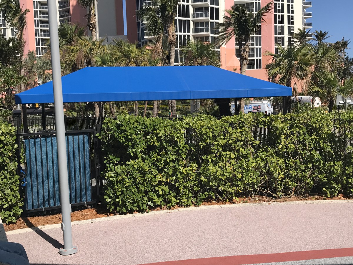 Blue shade canopy beside a pool area