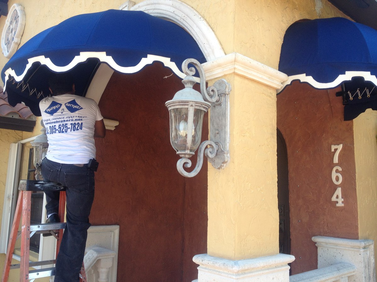 Crew member working on a navy entry awning