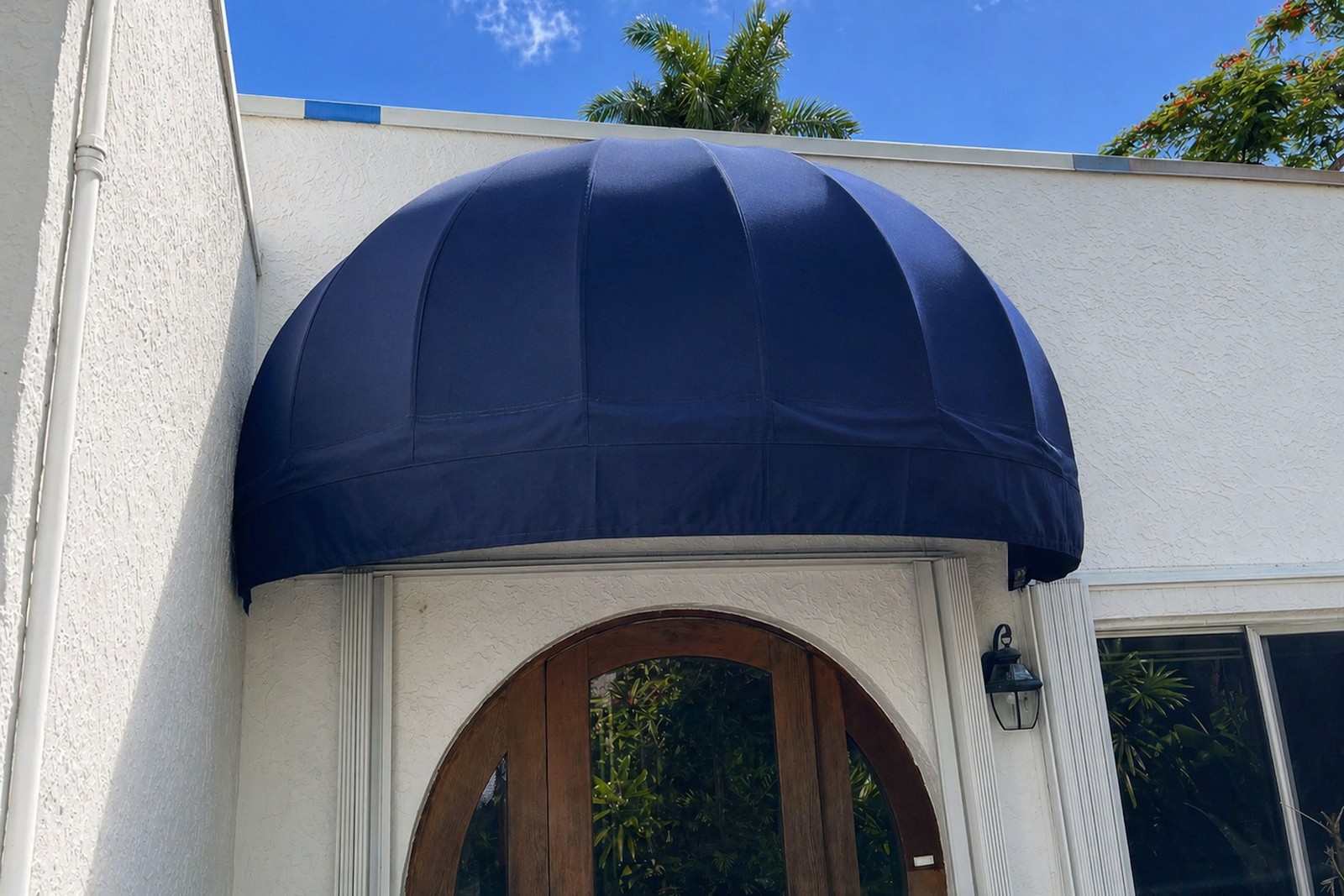 Navy dome awning over an arched entry